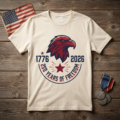 Styled flatlay of 1776-2026 eagle natural tee with medals