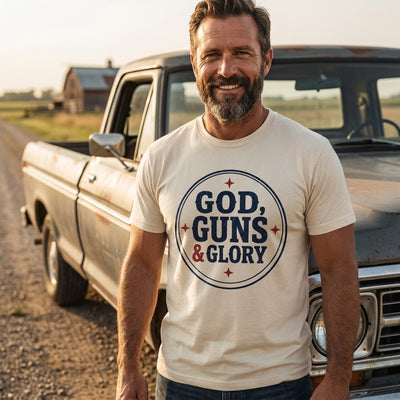 Man wearing God Guns and Glory natural tee by vintage pickup truck