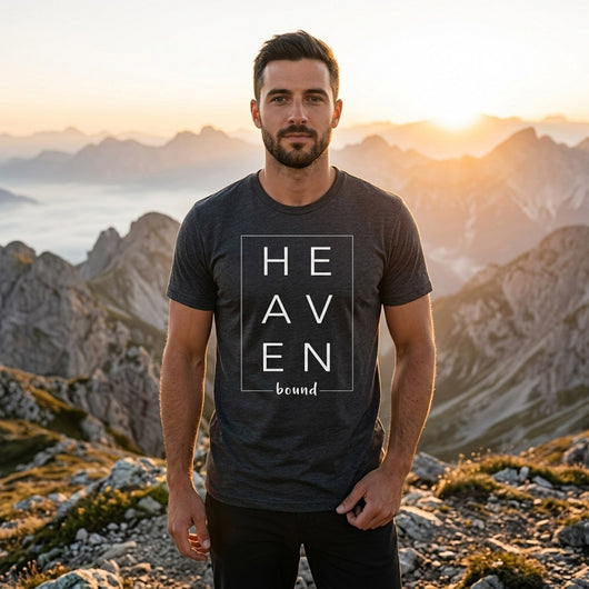 Man at mountain sunrise wearing Heaven Bound dark heather tee