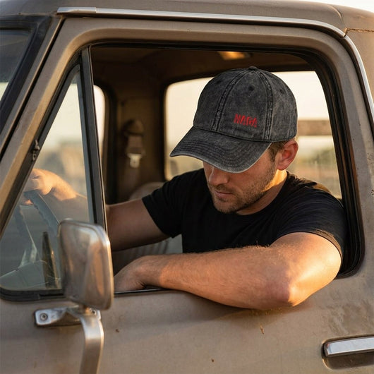 Man in pickup truck wearing vintage black MAGA dad hat