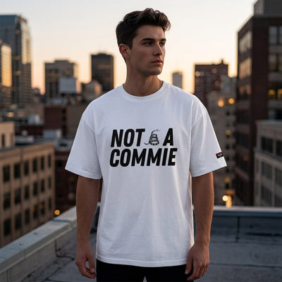 Man on city rooftop wearing white Not A Commie oversized tee