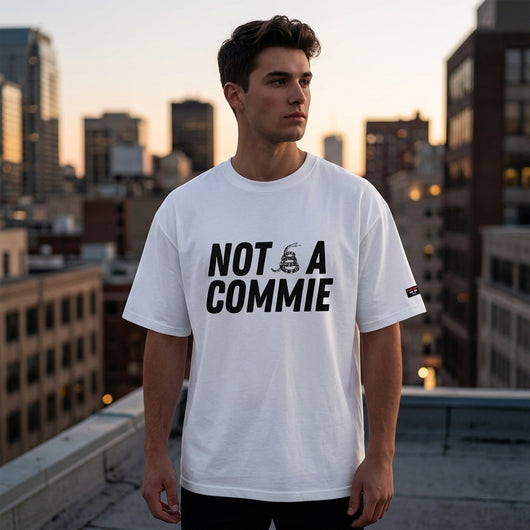 Man on city rooftop wearing white Not A Commie oversized tee