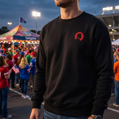 Man at tailgate wearing black Trump silhouette sweatshirt